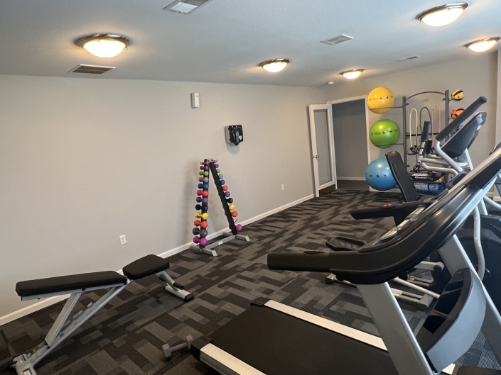 Fitness Center with treadmills and a bench
